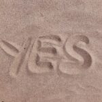yes text on brown sand