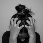 a woman covering her face with her hands