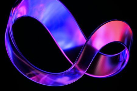 a close up of a purple ribbon on a black background