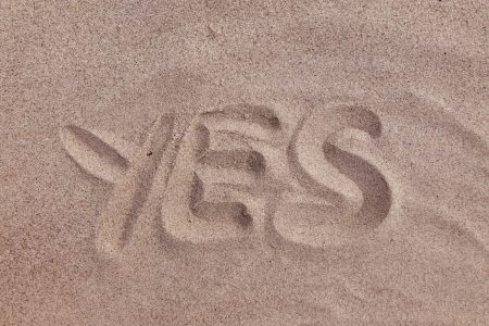 yes text on brown sand