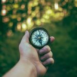 person holding compass
