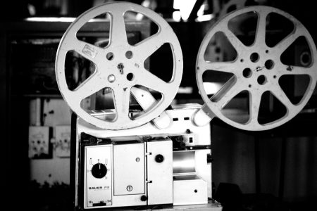 Black and white image of a retro film projector showcasing cinematographic equipment.